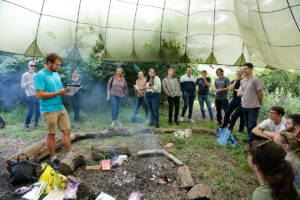 The team gather for the results of the scavenger hunt to discover the winning team. 