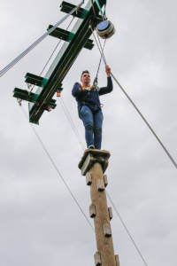 Sam Sefton, senior analyst, scaling the climbing pole. 