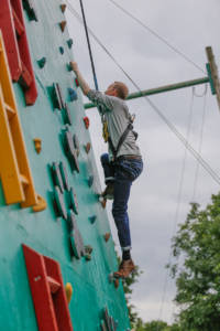 Nick Evans, trainee data engineer, tackling the climbing wall.